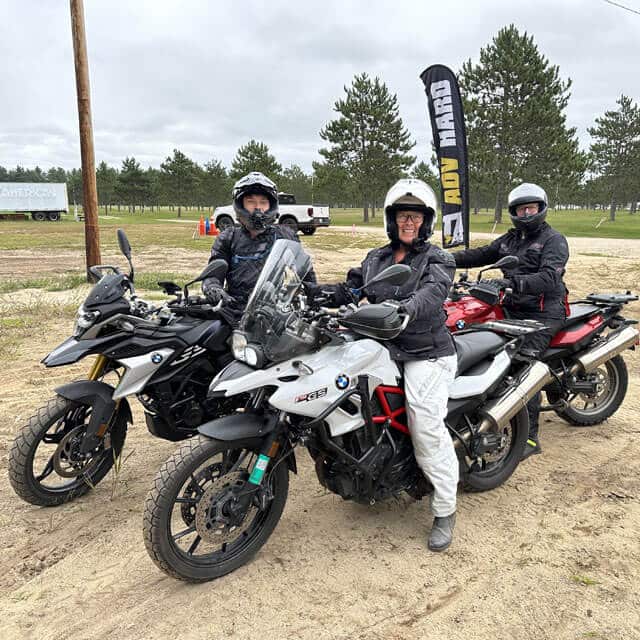 Cara Nelson with her son Carl and husband Jonathan, on their BMW GS's in an off road training class